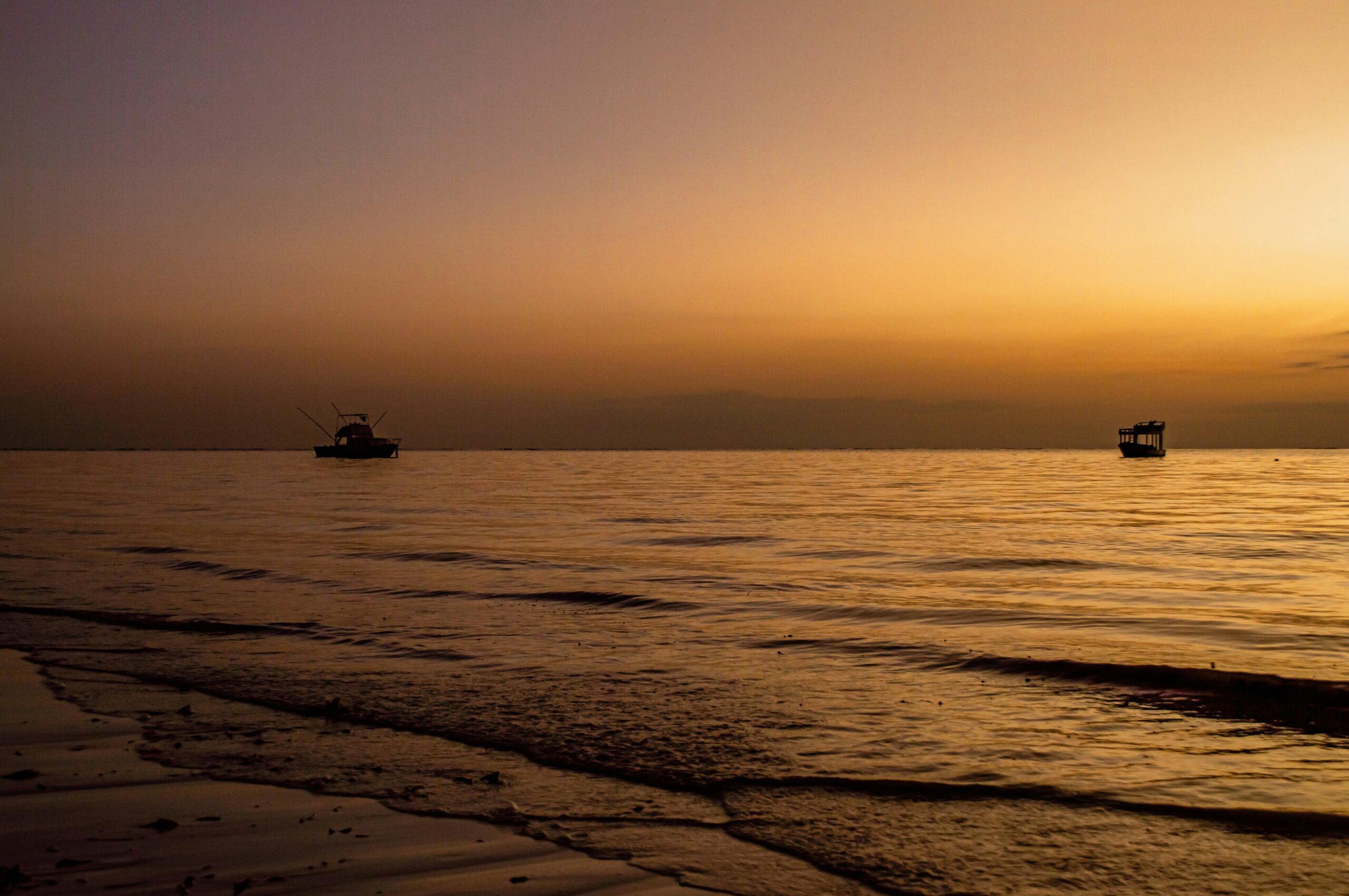The coast of Diani Beach at sunset.