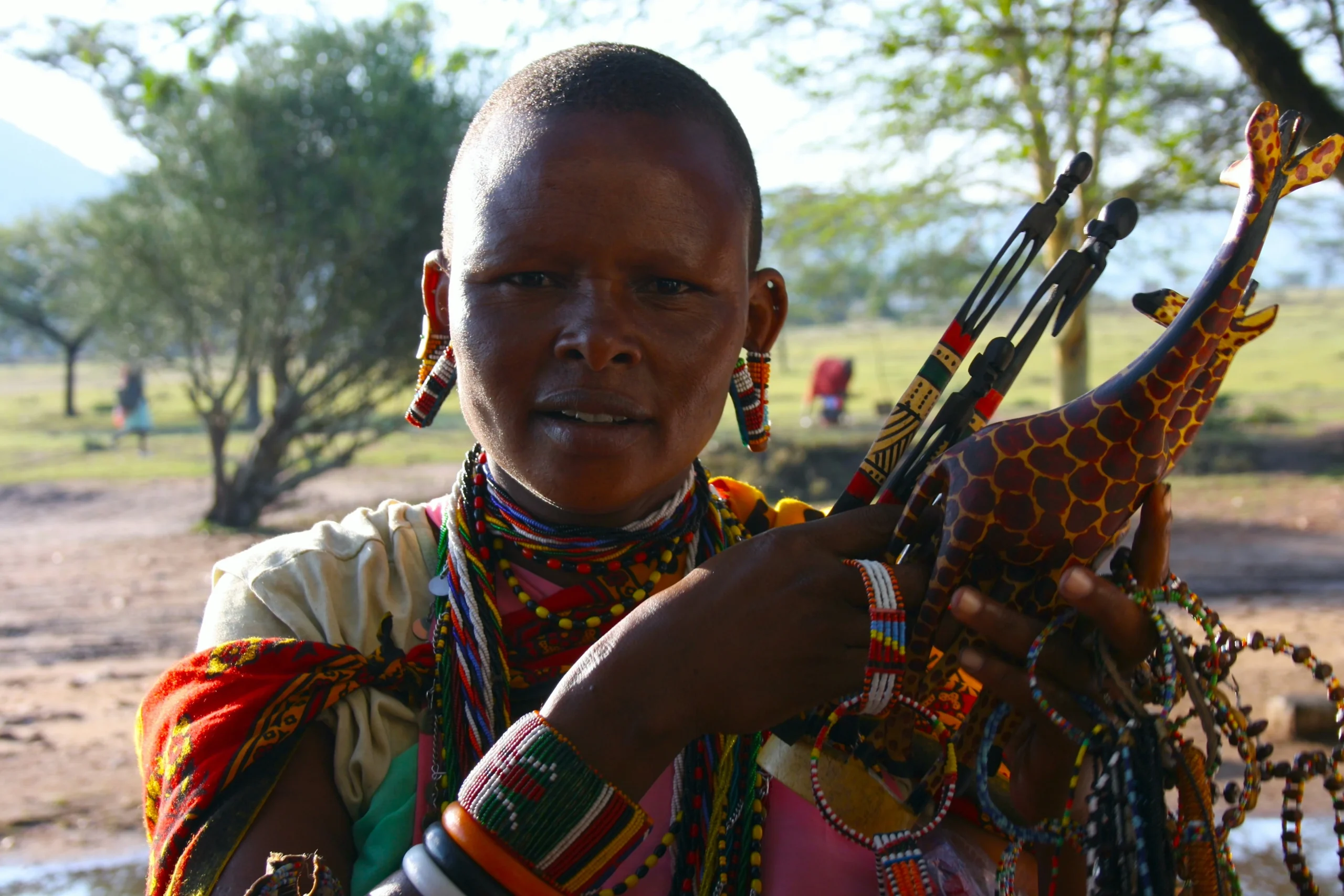 Maasai woman displaying handcraft souvenirs