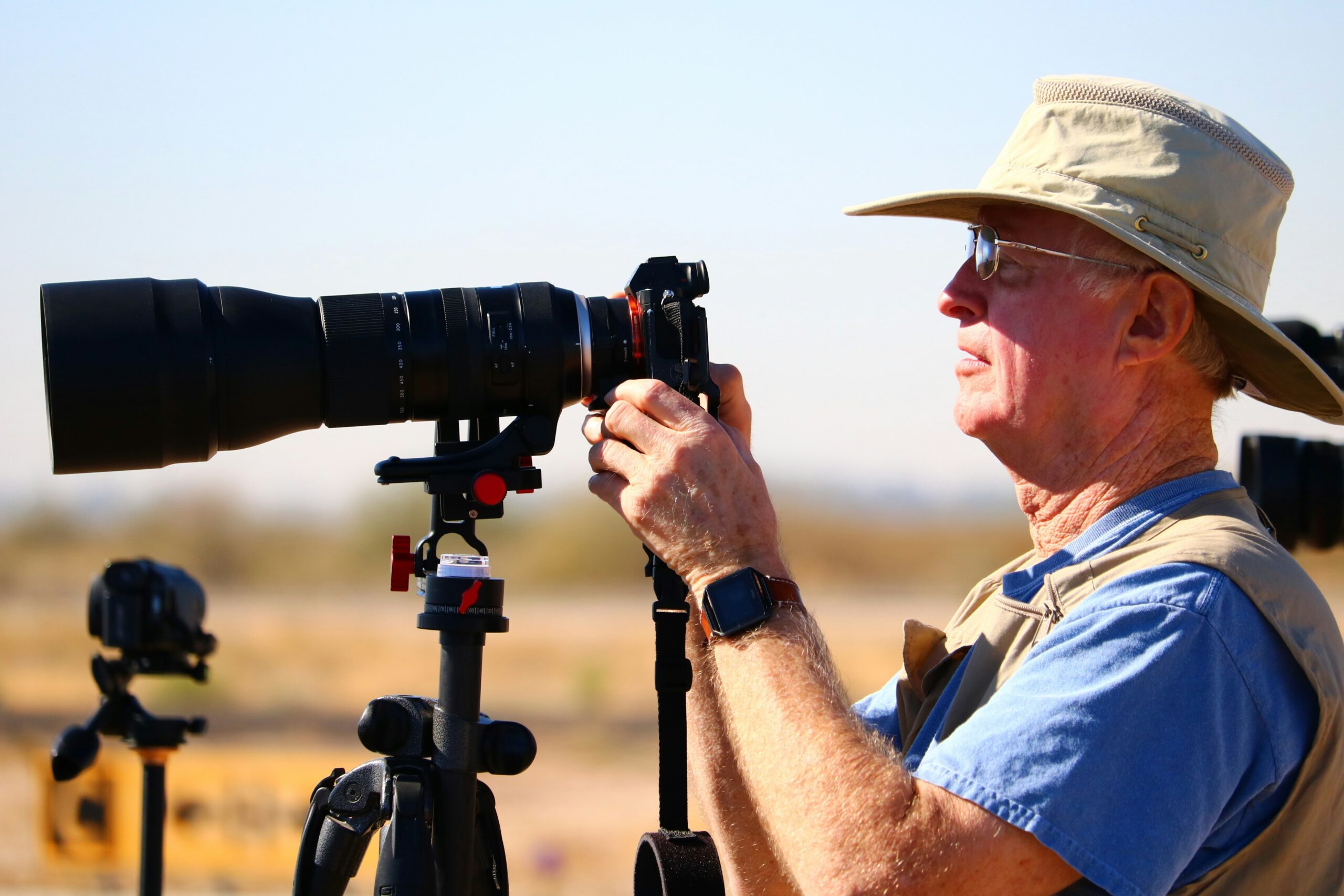 Birder using binoculars to spot species on a birding safari in Kenya