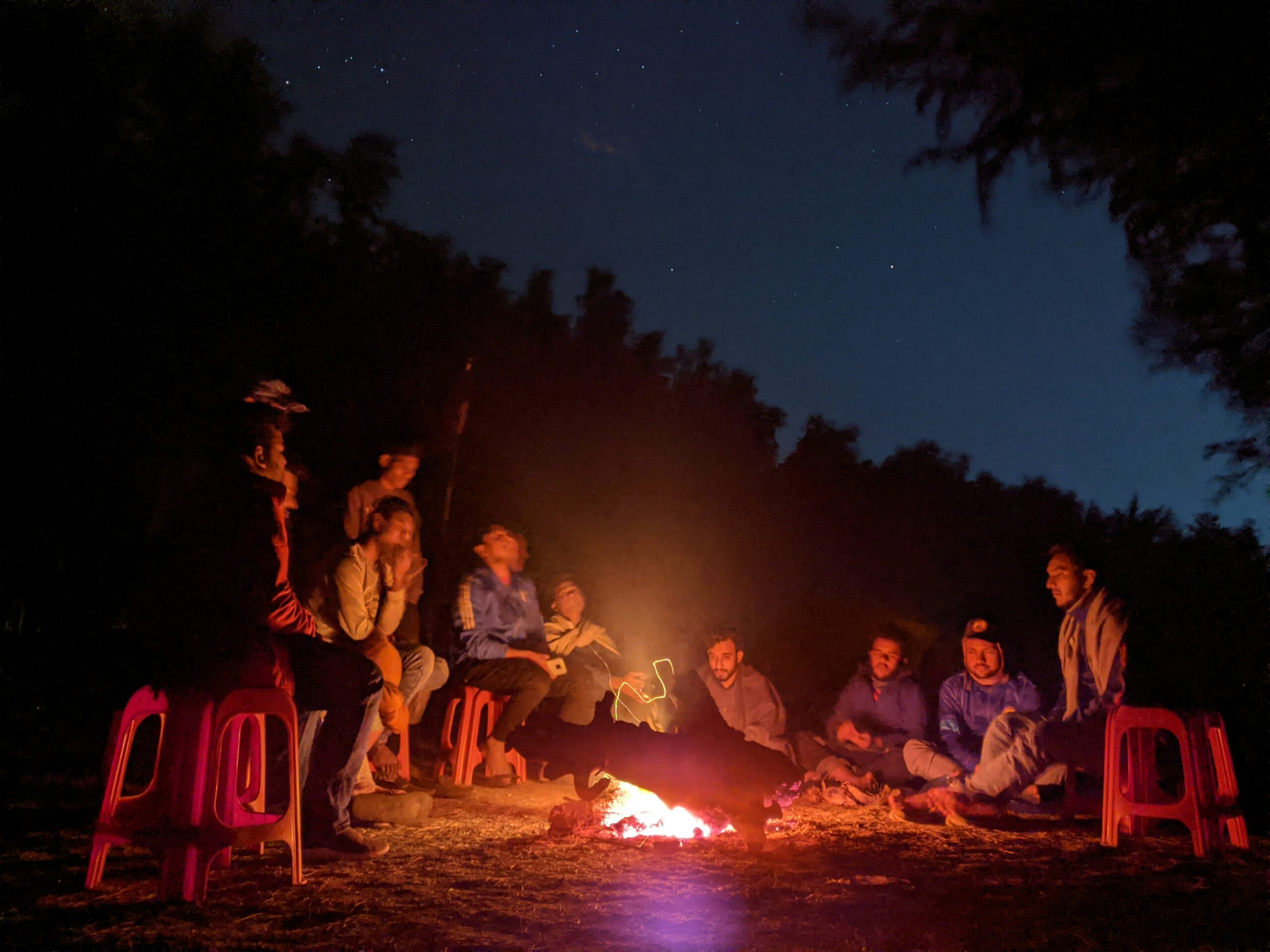 Children enjoying safari storytelling around a campfire