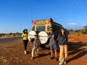Our clients cresting memories at one of the scenic roads in Kenya, the Nairobi-Amboseli road