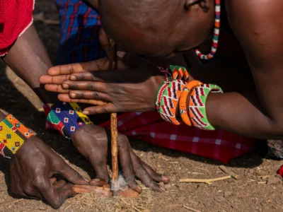 maasai men lighting a fire wit sticks the maasai lighting a fire with sticks on a maasai village visit in masai mara