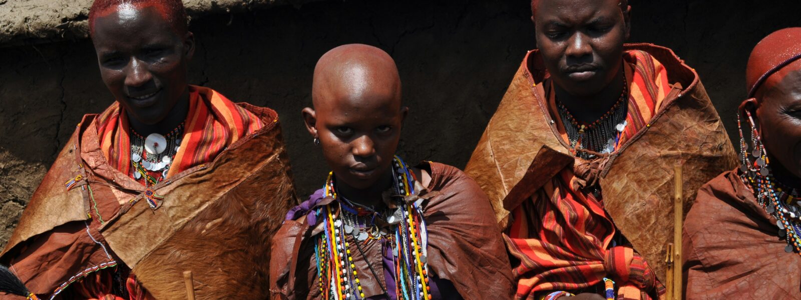 Traditional Maasai village with manyatta huts in the savanna landscape of Kenya.